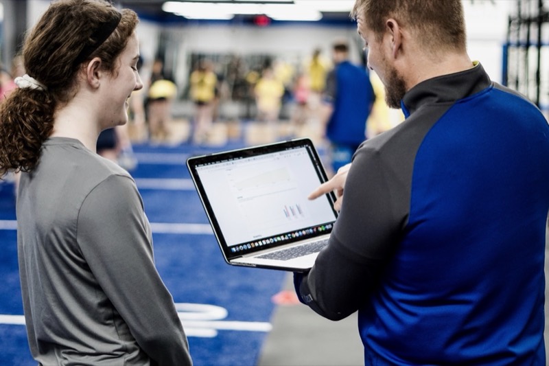 Oak Strength coach reviewing athlete performance data in Loves Park IL